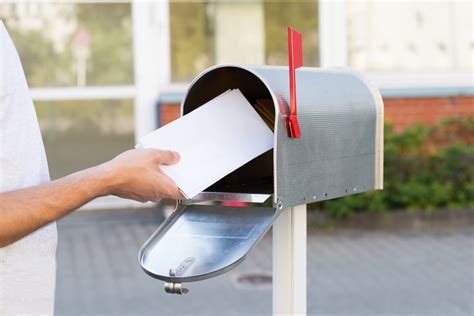 putting business cards in a mailbox